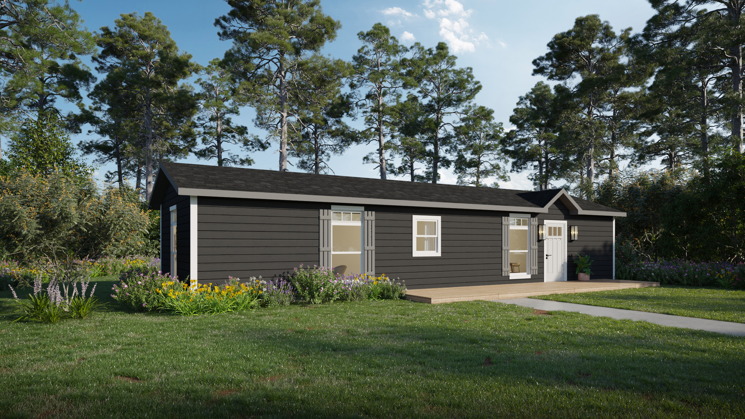 A small black house with white trim sits in a grassy yard surrounded by trees and wildflowers under a blue sky.