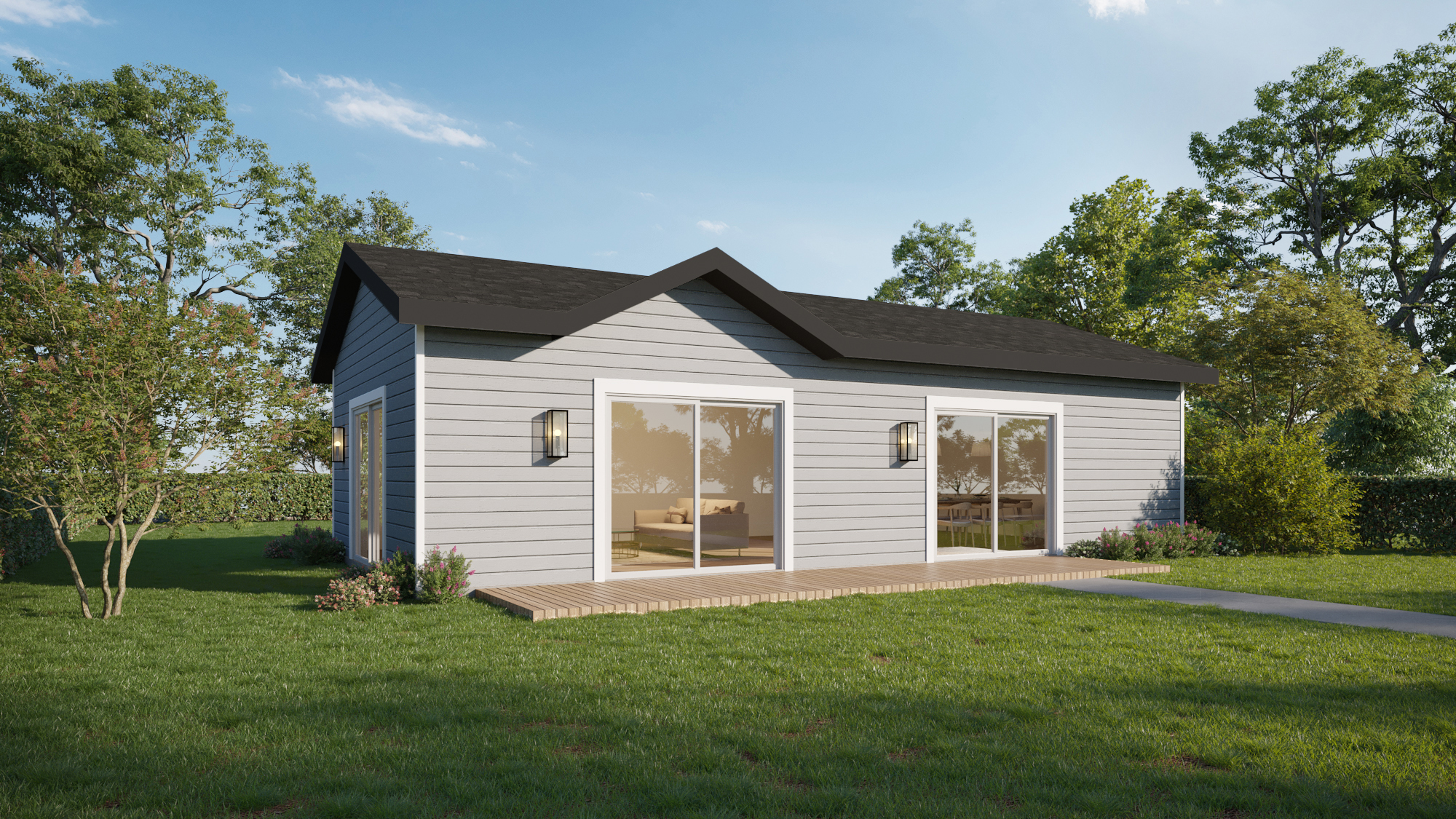 A small, modern gray house with a black roof, large glass doors, and a wooden deck, surrounded by grass and trees under a clear blue sky.