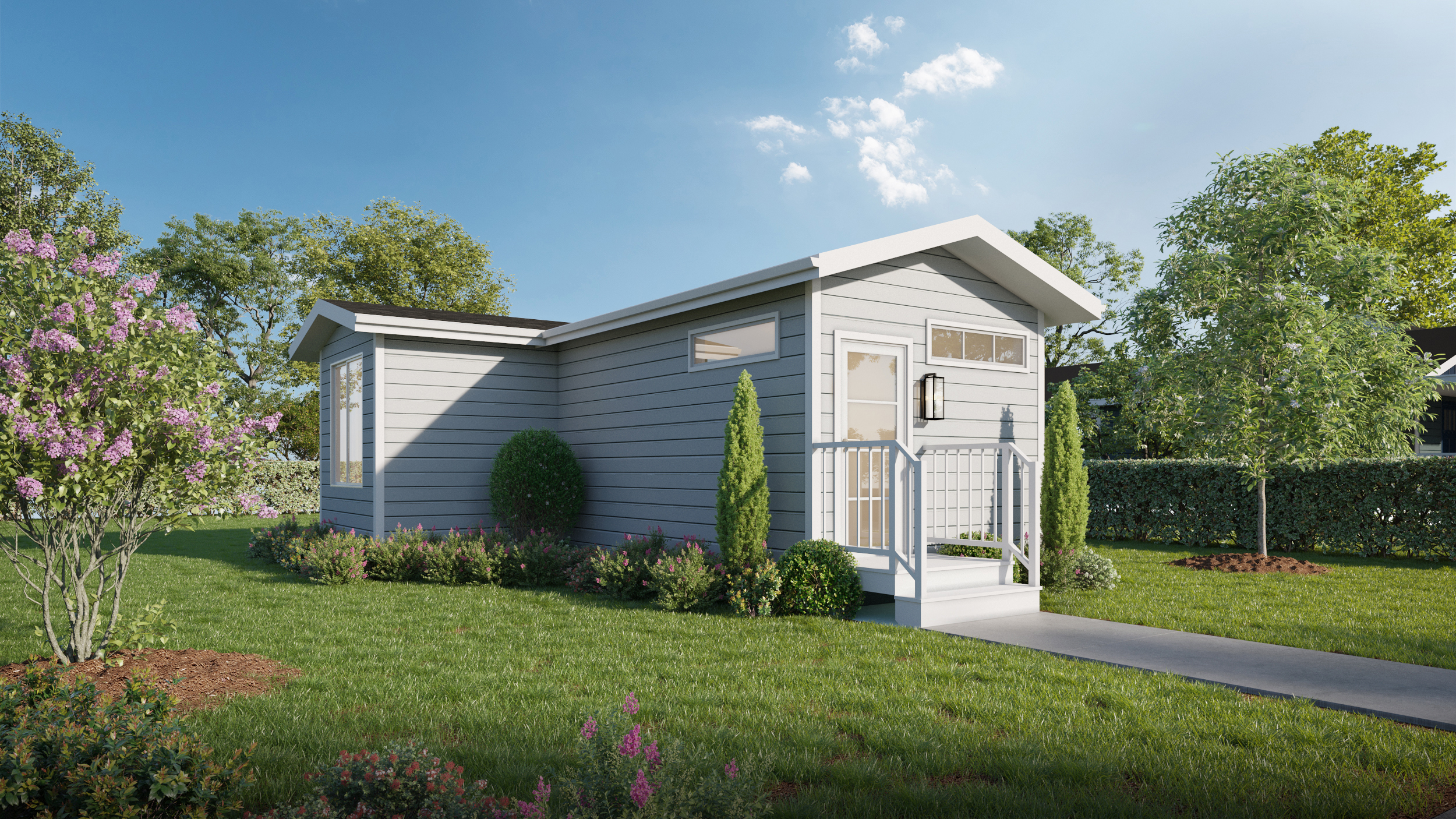 A small, modern gray tiny house with white trim, front porch, and surrounding greenery under a blue sky.